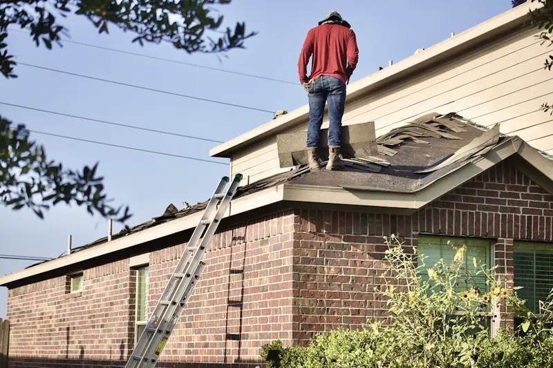 Professional roofer working on a residential roof in Pitsburg